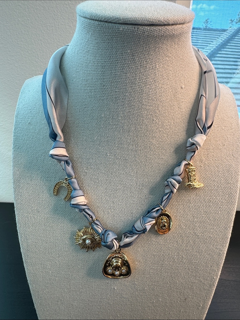 Gold Charm Necklace with Light Blue Fabric Twist